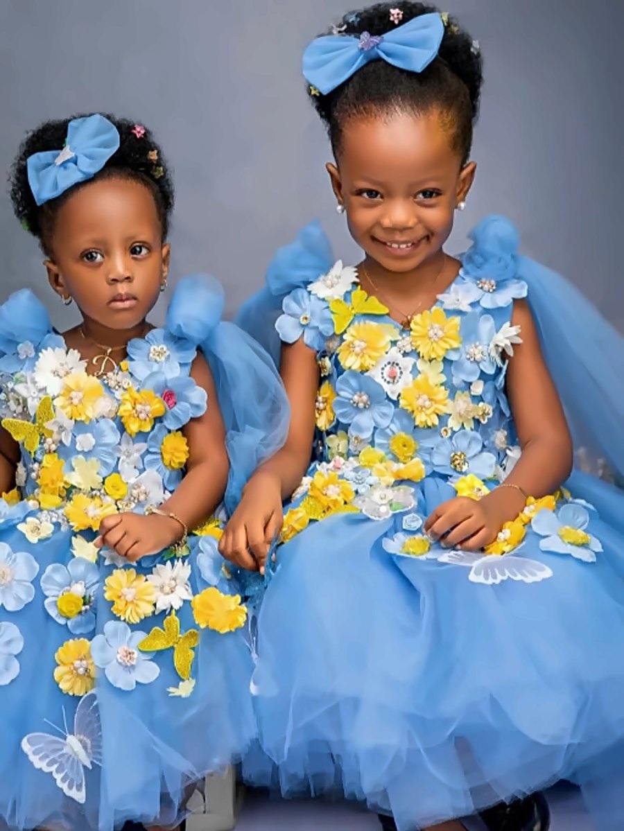 Two sisters in blue butterfly gowns
